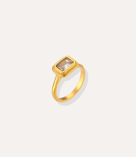 Solitaire Ring in 18k gold plated finish, featuring a single sparkling stone in a vintage setting, isolated on a white background.