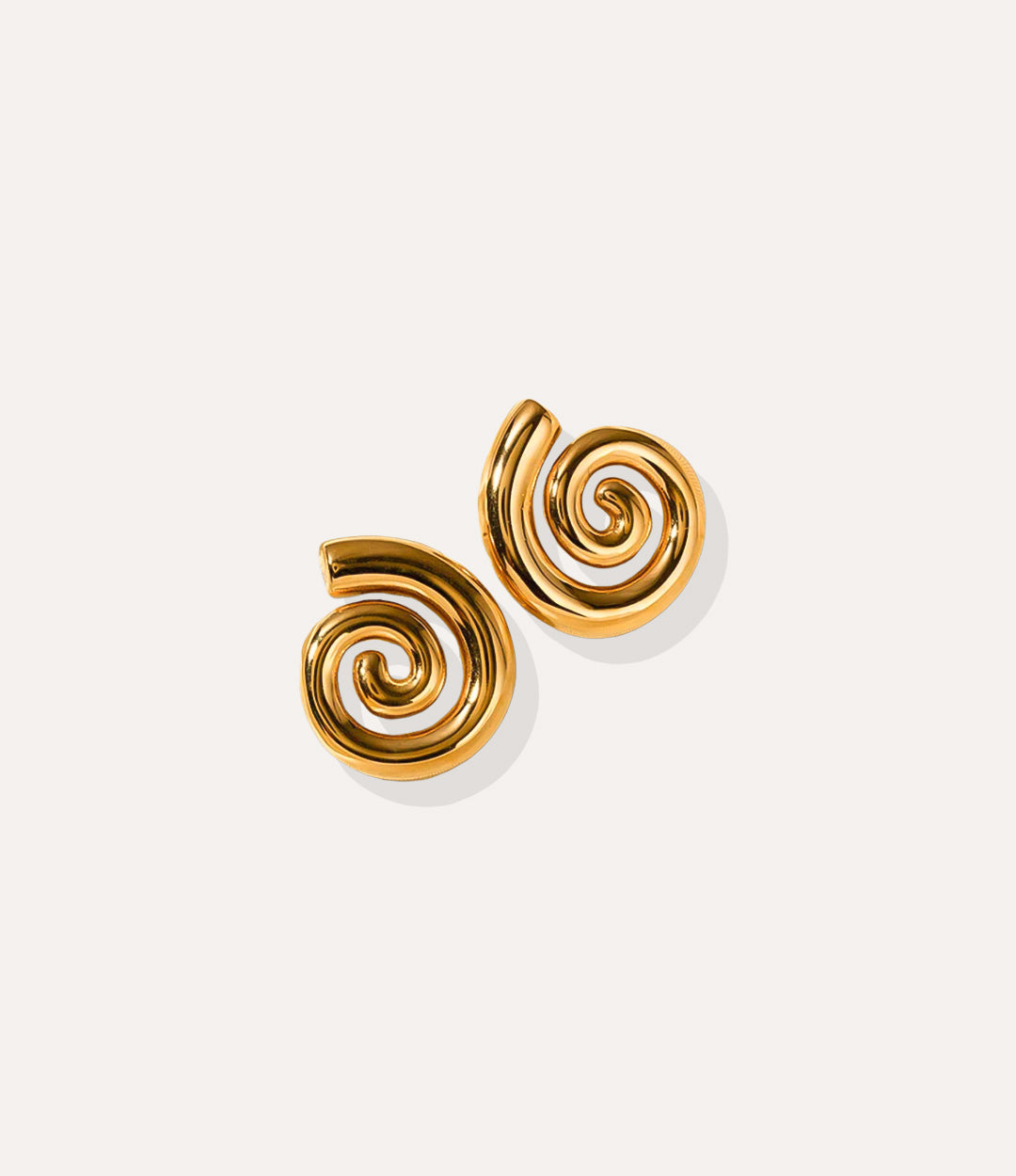 Close up of the Spiral Studs in gold, highlighting the twisted spiral silhouette and polished 18k gold plating.