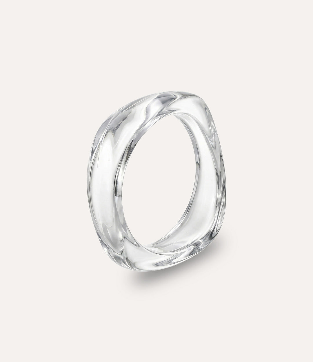 Chunky square bangle made of acrylic and resin in clear colour displayed on a neutral background.