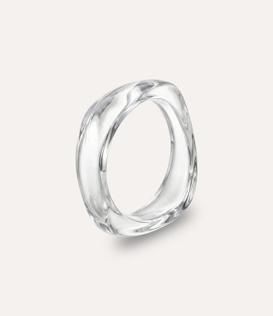 Chunky square bangle made of acrylic and resin in clear colour displayed on a neutral background.