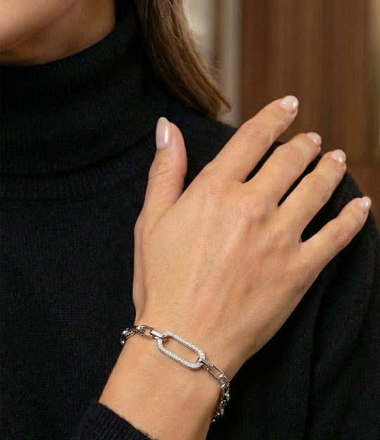 Model wearing the Square Link Bracelet in silver, showcasing its sleek and elegant modern design
