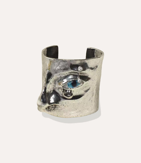 Statement Eye Cuff bracelet featuring a bold face-inspired eye design in silver on a neutral background.