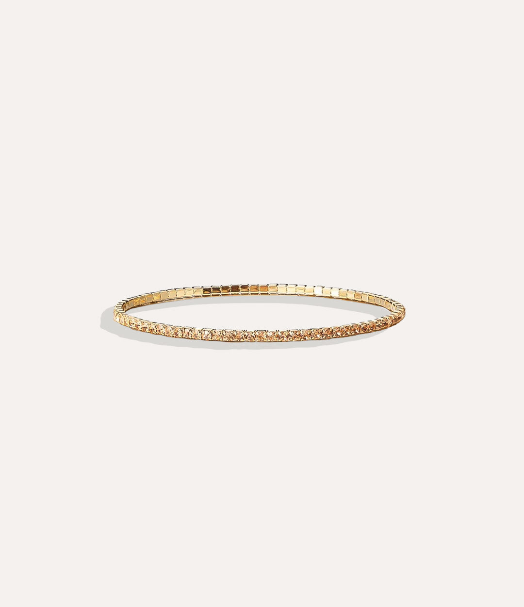 Stretch Tennis Bracelet in 14K gold-plated stainless steel with vibrant gold gemstone accents displayed in a close-up product image.
