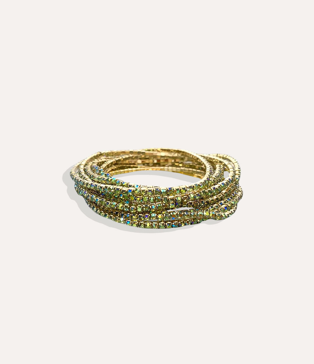 Stretch Tennis Bracelet in 14K gold-plated stainless steel with vibrant green gemstone accents displayed in a close-up product image.