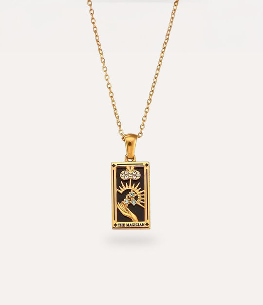The magician - gold tarot card pendant necklace with link chain displayed on a neutral background.