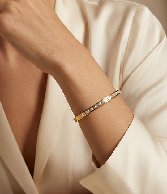 Model wearing The Princess Diamond Bangle, showcasing its classic gold bangle design with sparkling diamond-style stones