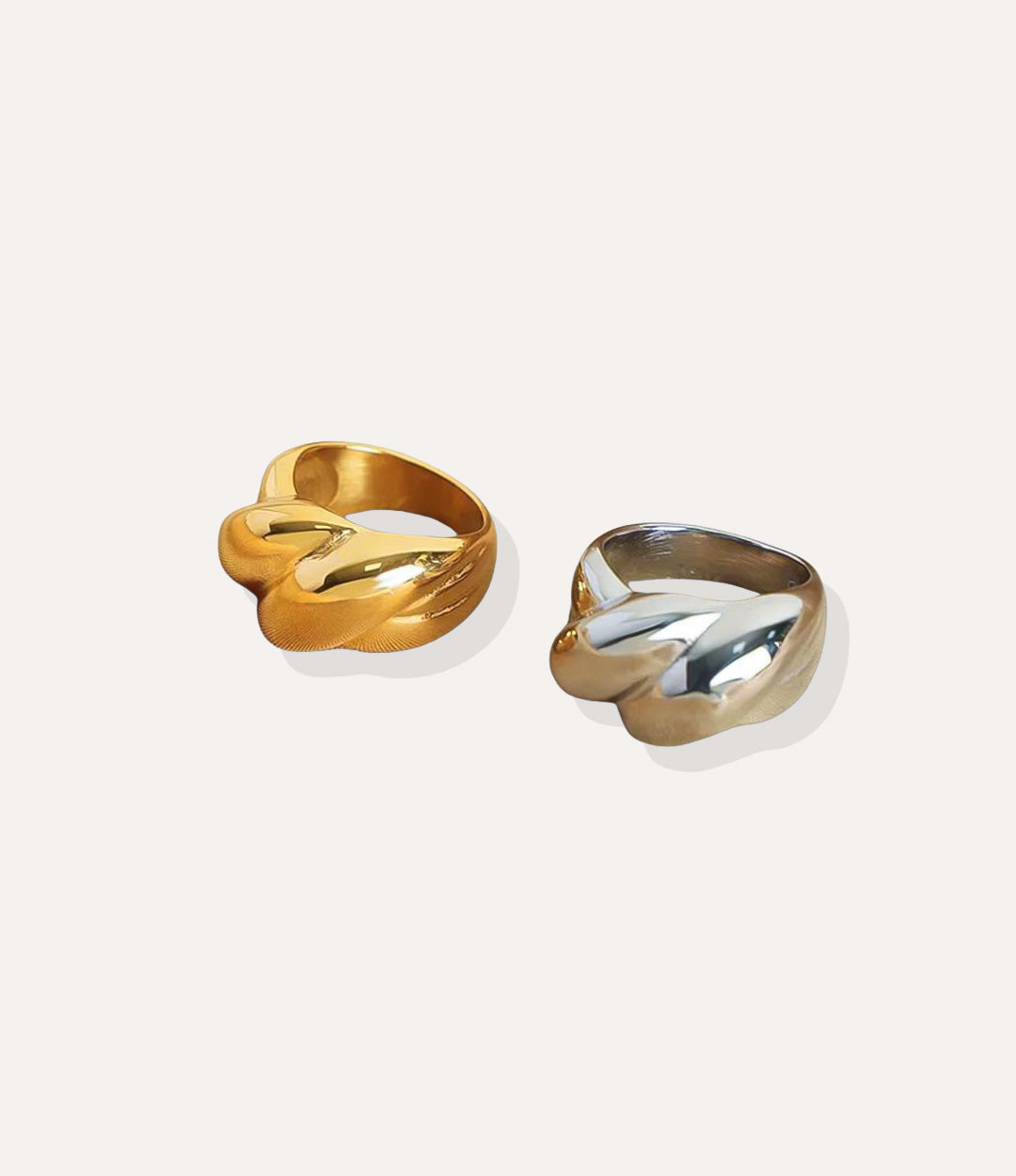 The Big Twist Ring in 18k gold plated finish and silver, featuring a thick rope-style twisted band design, isolated on a white background.