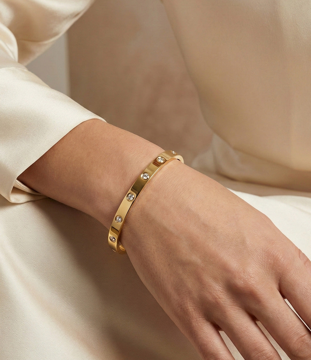 Model wearing The Carter Bangle alone for a minimalist gold bracelet look.