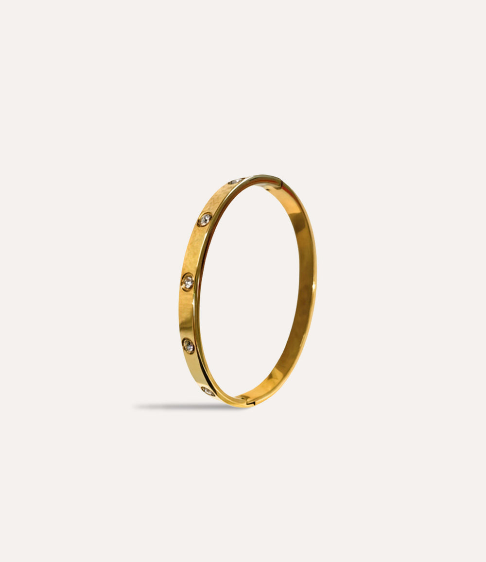 The Carter Bangle in 14k gold plated finish displayed on a neutral background.