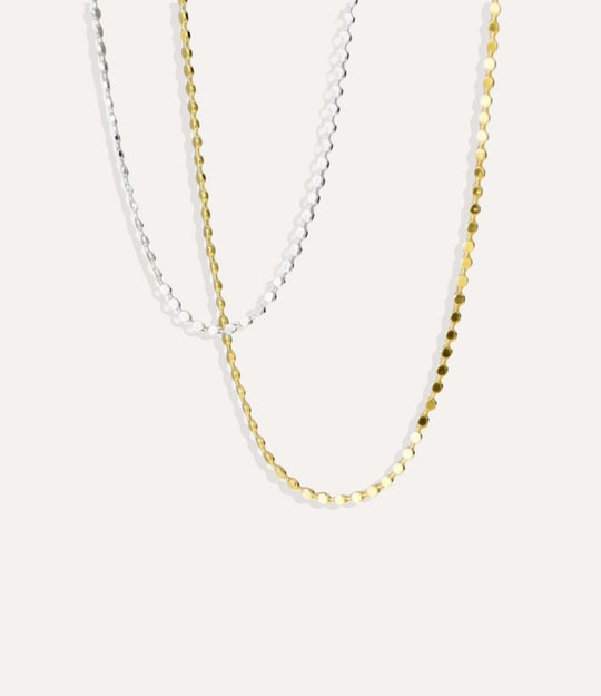 Gold and Silver Disco Chain Necklaces with flat round discs displayed on a neutral background