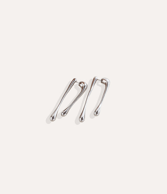 Close up of The Drip Earrings in silver featuring the polished drip-inspired design.