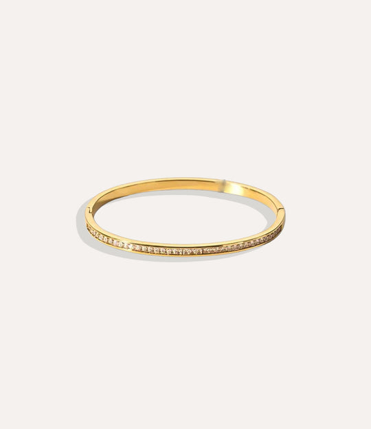 The Duchess Bangle in 18k gold plated stainless steel displayed on a neutral background.”