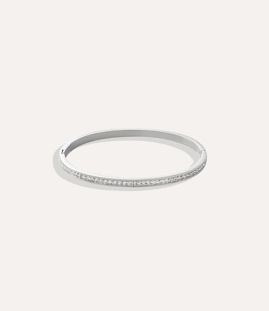 The Duchess Bangle in stainless steel displayed on a neutral background.”