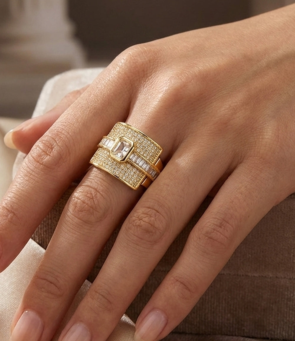 Woman's hand modeling The Empress Ring on the middle finger, showcasing the bold statement design and sparkling diamond accents.