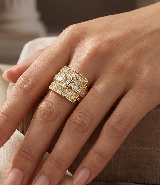 Woman's hand modeling The Empress Ring on the middle finger, showcasing the bold statement design and sparkling diamond accents.