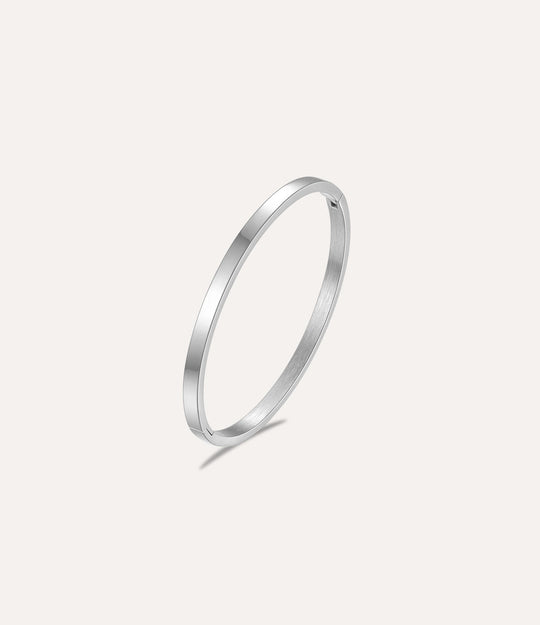 The Essential Bangle in titanium steel displayed on a clean white background