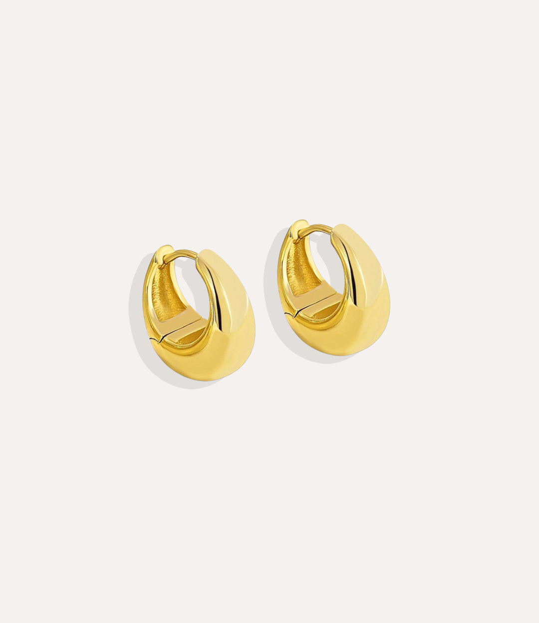 Product shot of The Essential Hoops in 18k gold plating displaying the smooth tear drop shape and high shine finish on a white background.