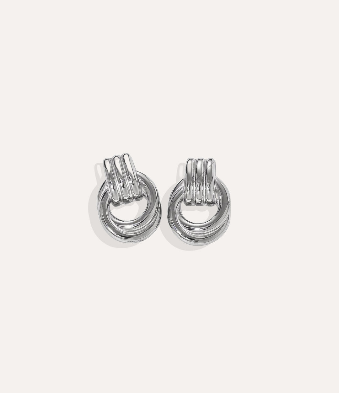 Product shot of The Knot Earring in silver colour showing the cool stainless steel finish and durable construction on a white background.