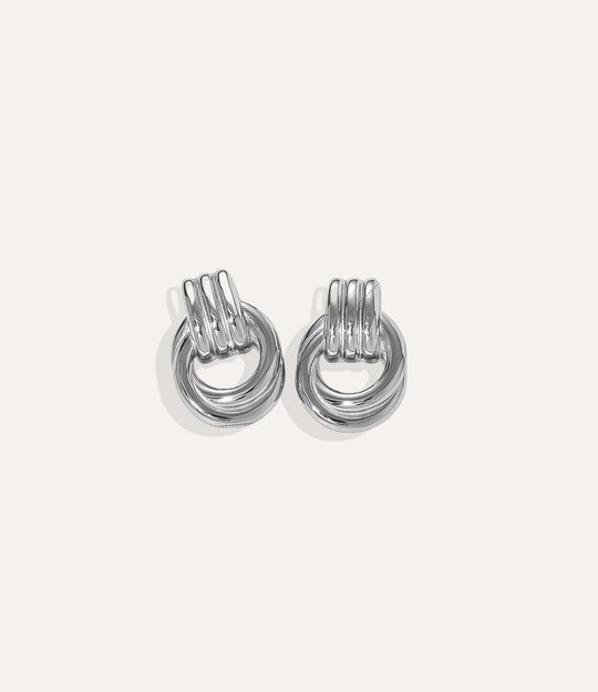 Product shot of The Knot Earring in silver colour showing the cool stainless steel finish and durable construction on a white background.