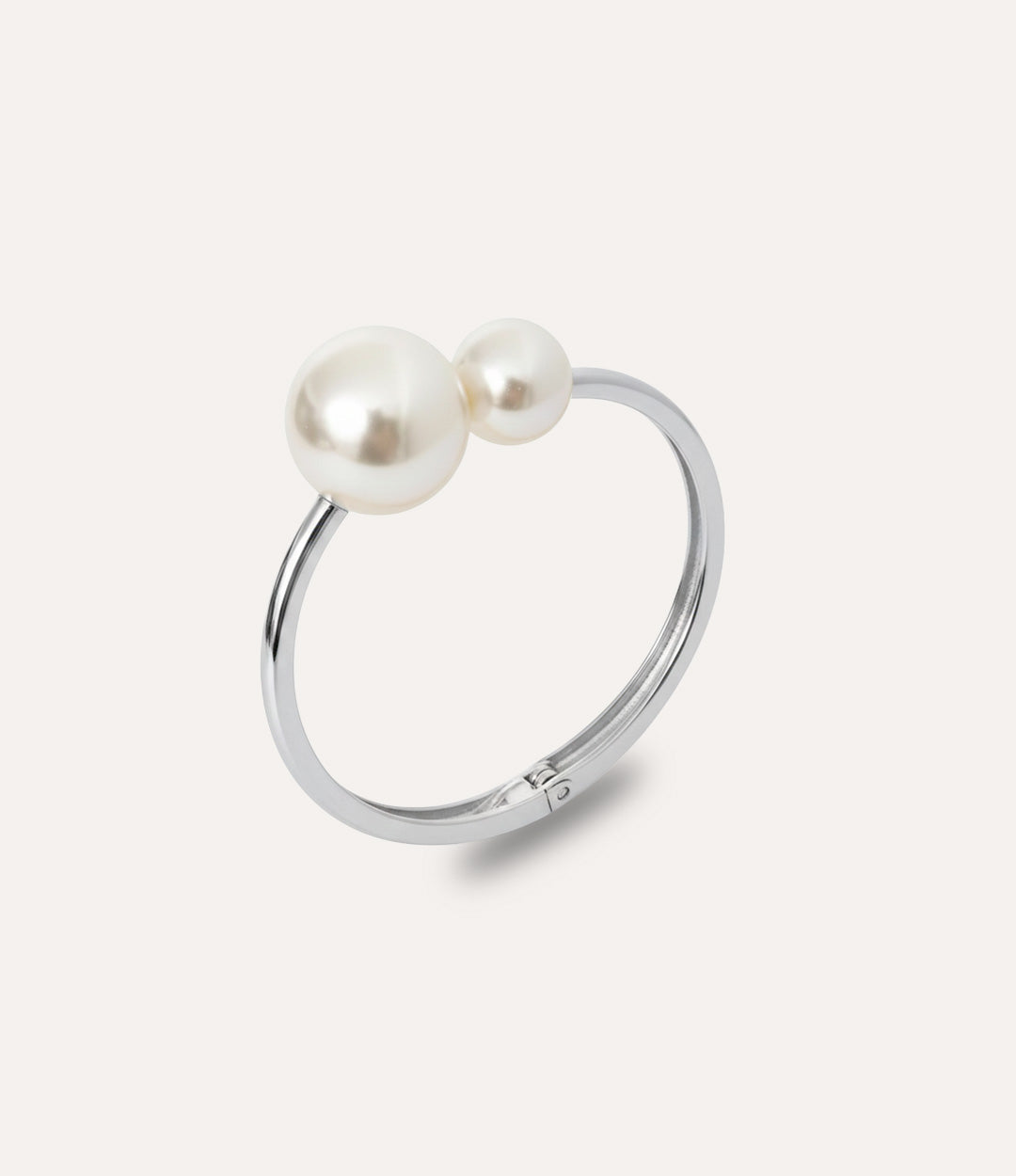 Silver pearl bangle with two asymmetric pearls displayed on a clean background.