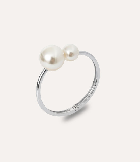 Silver pearl bangle with two asymmetric pearls displayed on a clean background.