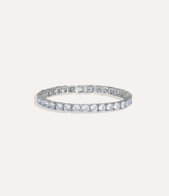 Tennis Bracelet Collection featuring silver-plated bracelets with round diamonds in 1k, 2k, and 3k sizes displayed on a neutral background.