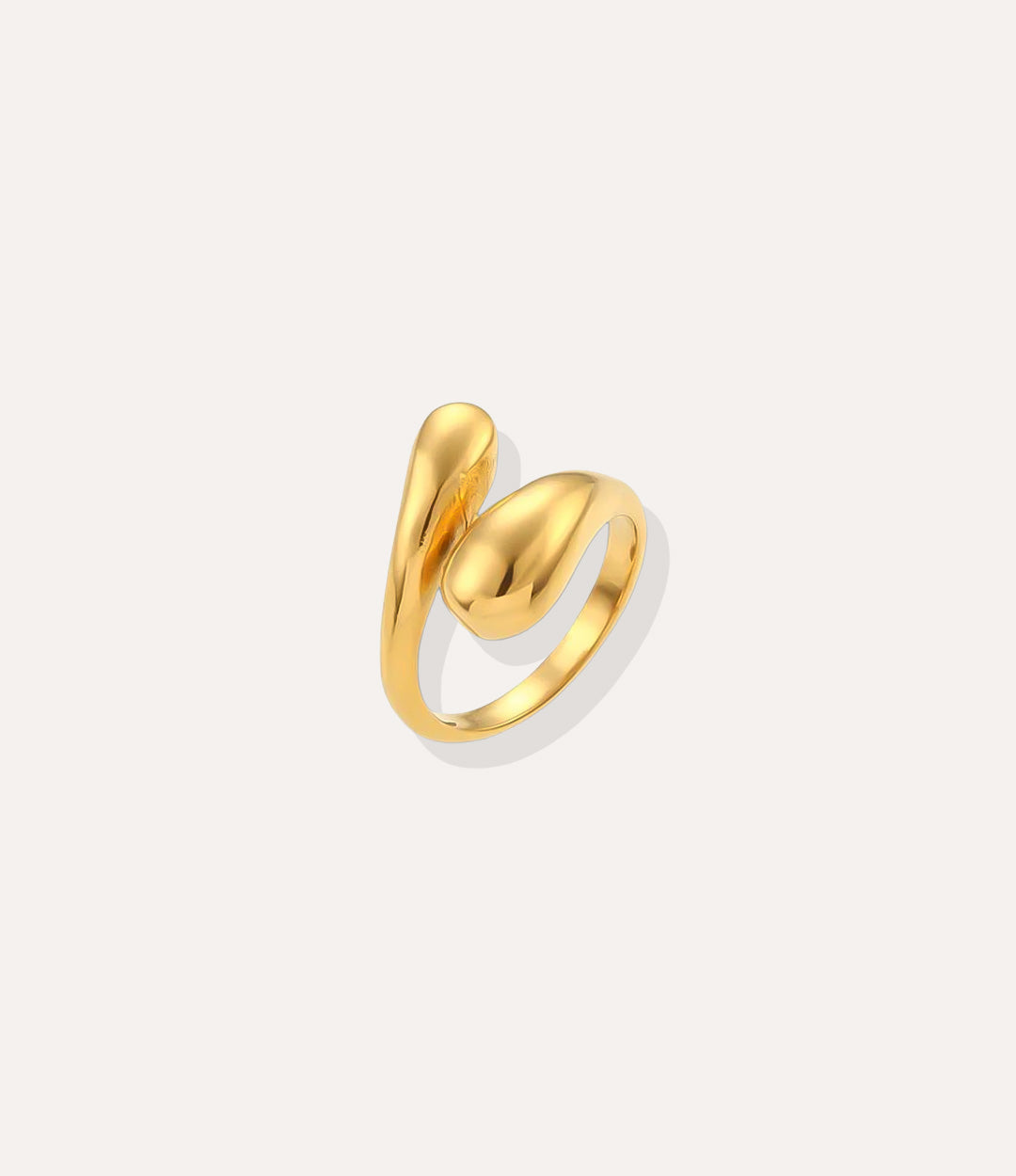 The Twist Ring in 14k gold plated stainless steel, featuring a fluid wrap-around spiral design, isolated on a white background.
