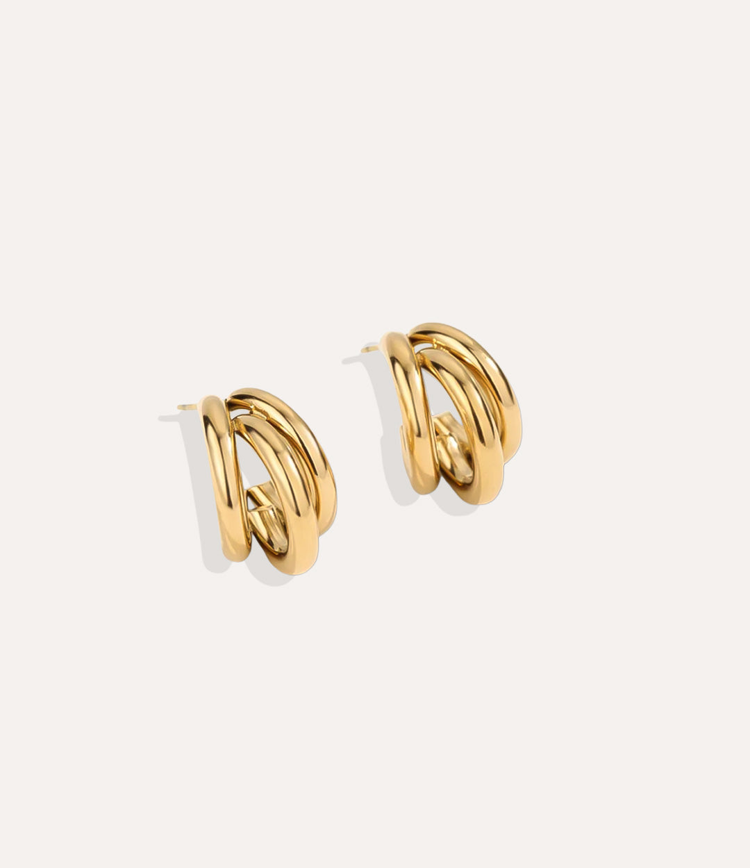 Product shot of the Three in One Hoops in 18k gold plating displaying the unique triple curve shape and high shine finish on a white background.