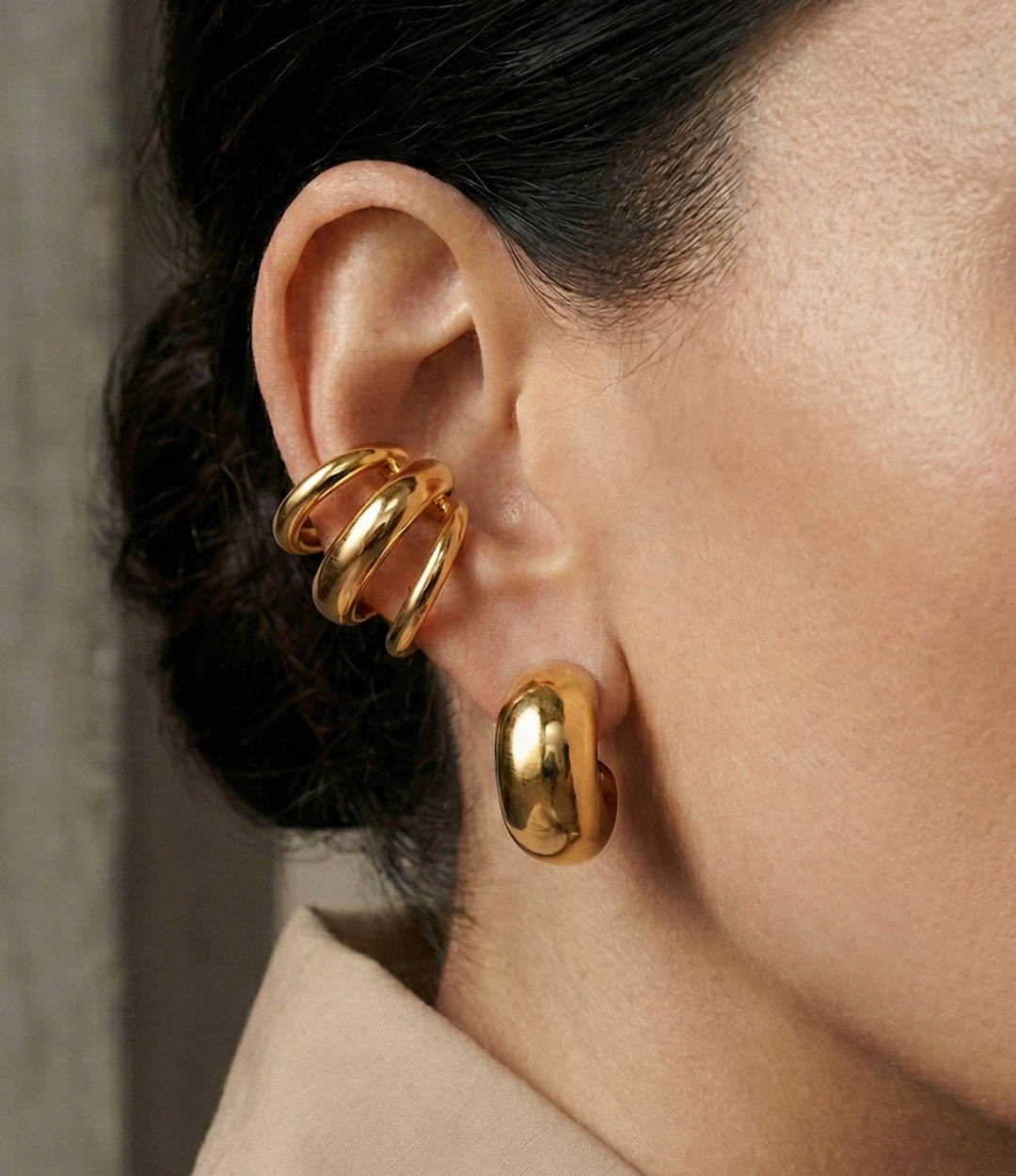 Model wearing the Triple Cuff, showing the sleek triple-band design and stylish stacked look on the ear.