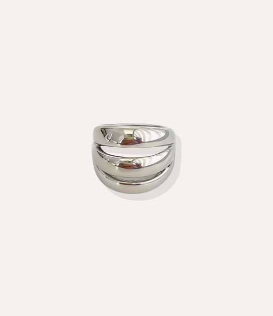 Stainless steel silver Triple Stack Ring, highlighting the cool polished finish and the simplistic, modern triple-band design.