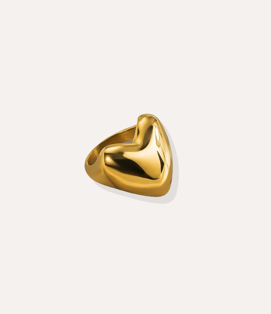 True Love Ring in 18k gold plated finish, featuring a sleek heart-shaped statement design made of waterproof stainless steel, isolated on white.