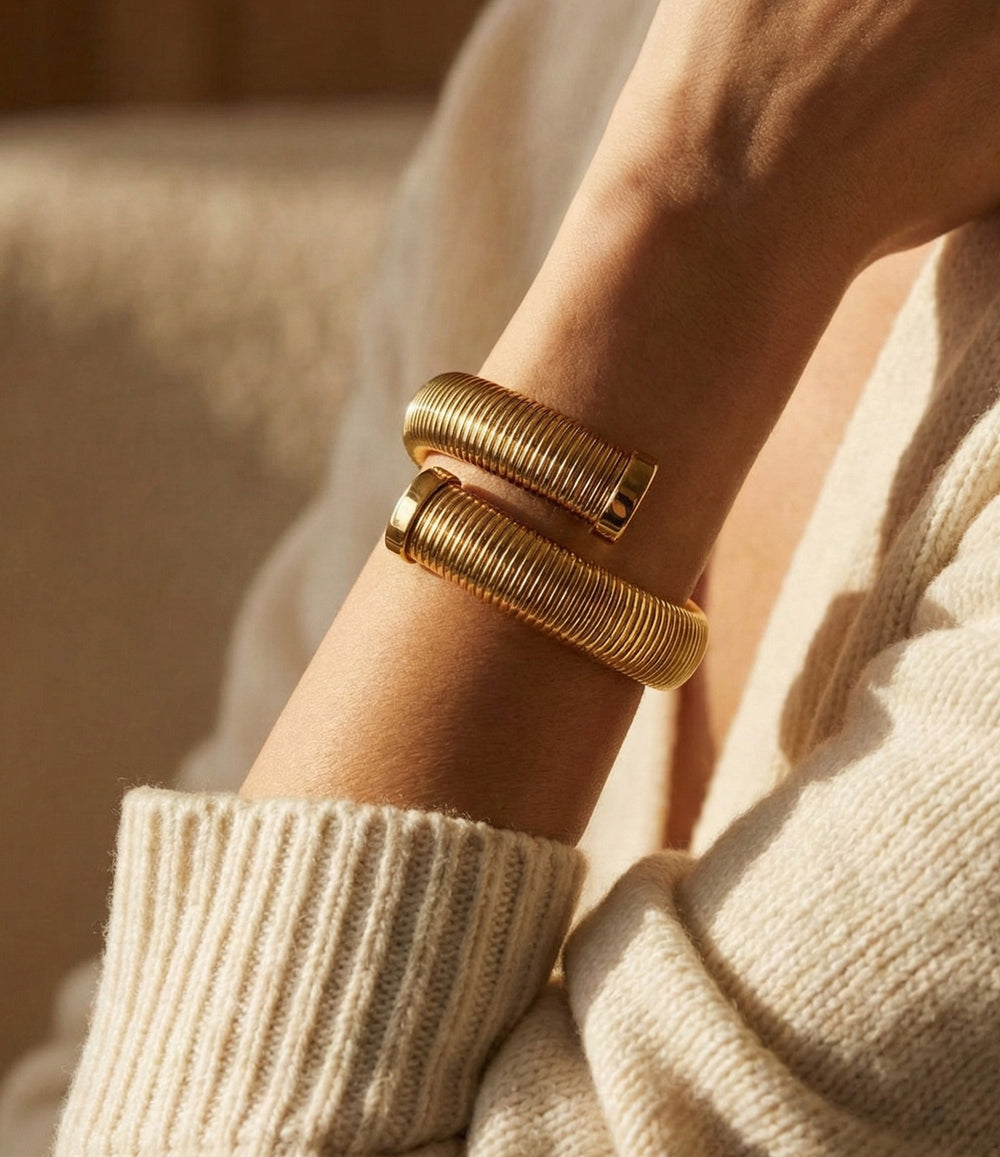 Model wearing the 18k gold-plated 16mm Twisted Snake Bangle, showing its twisted textured design