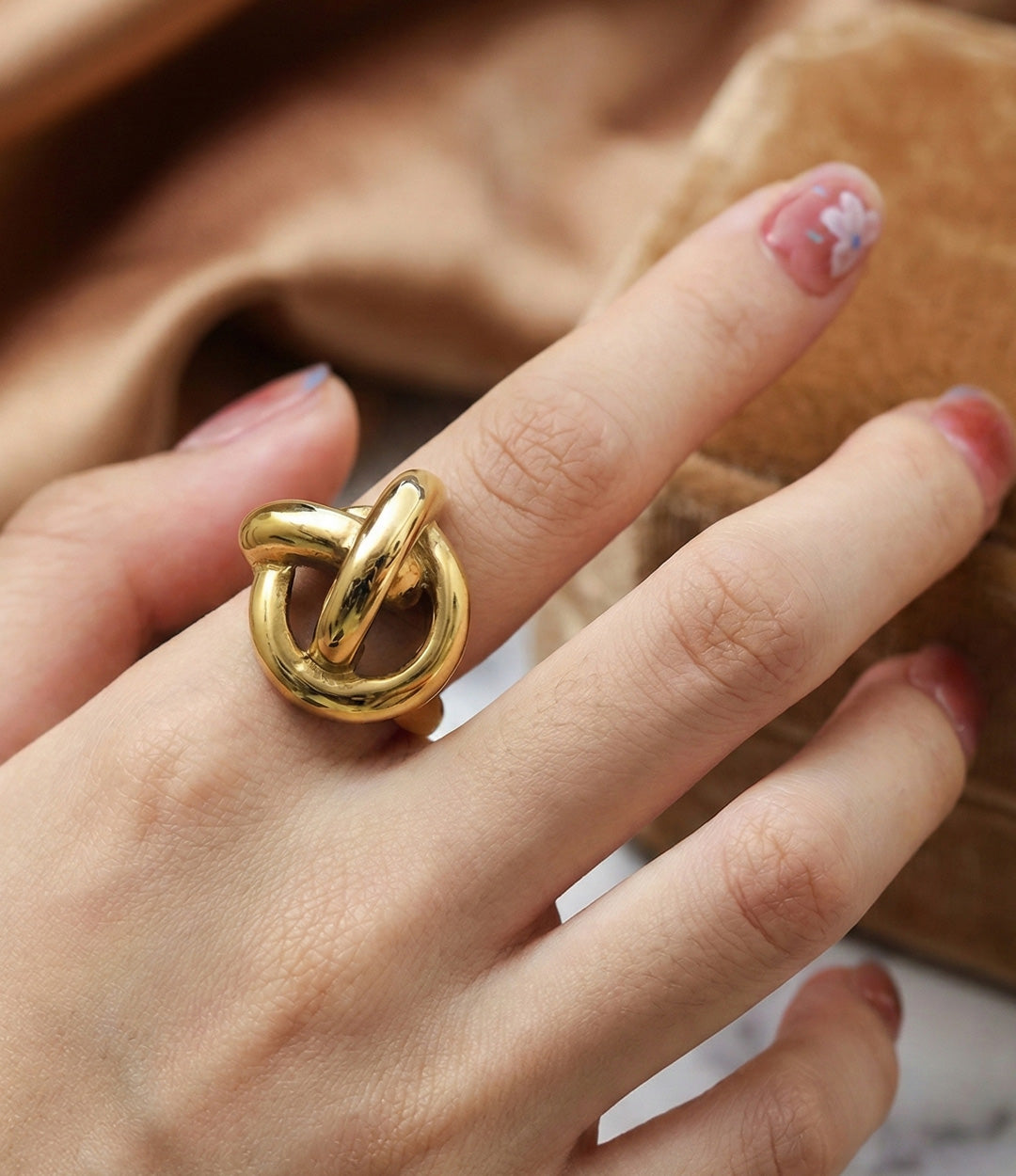 Woman's hand modeling the Twisted Statement Ring alone on the index finger, showcasing the chunky vintage-inspired silhouette and bold presence.