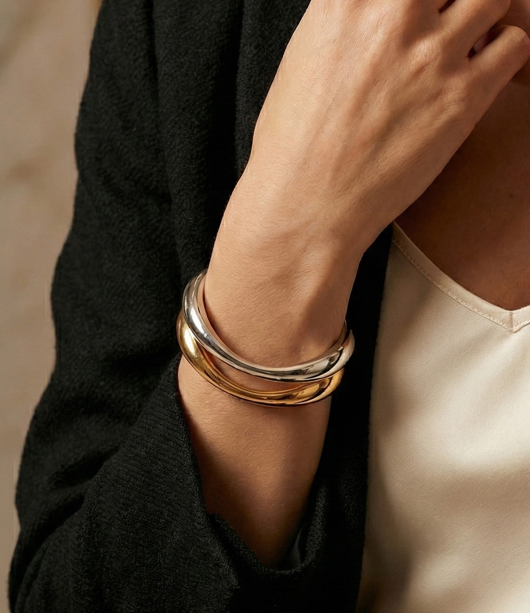 Model wearing the Wave Cuff in silver and gold, showcasing its stylish and contemporary look.