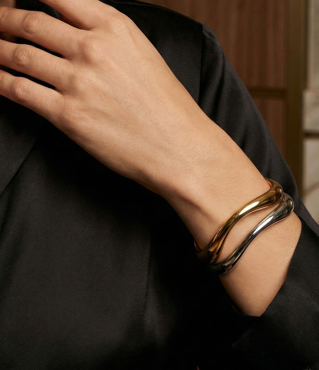 Model wearing the Wave Cuff in silver and gold, showcasing its stylish and contemporary look